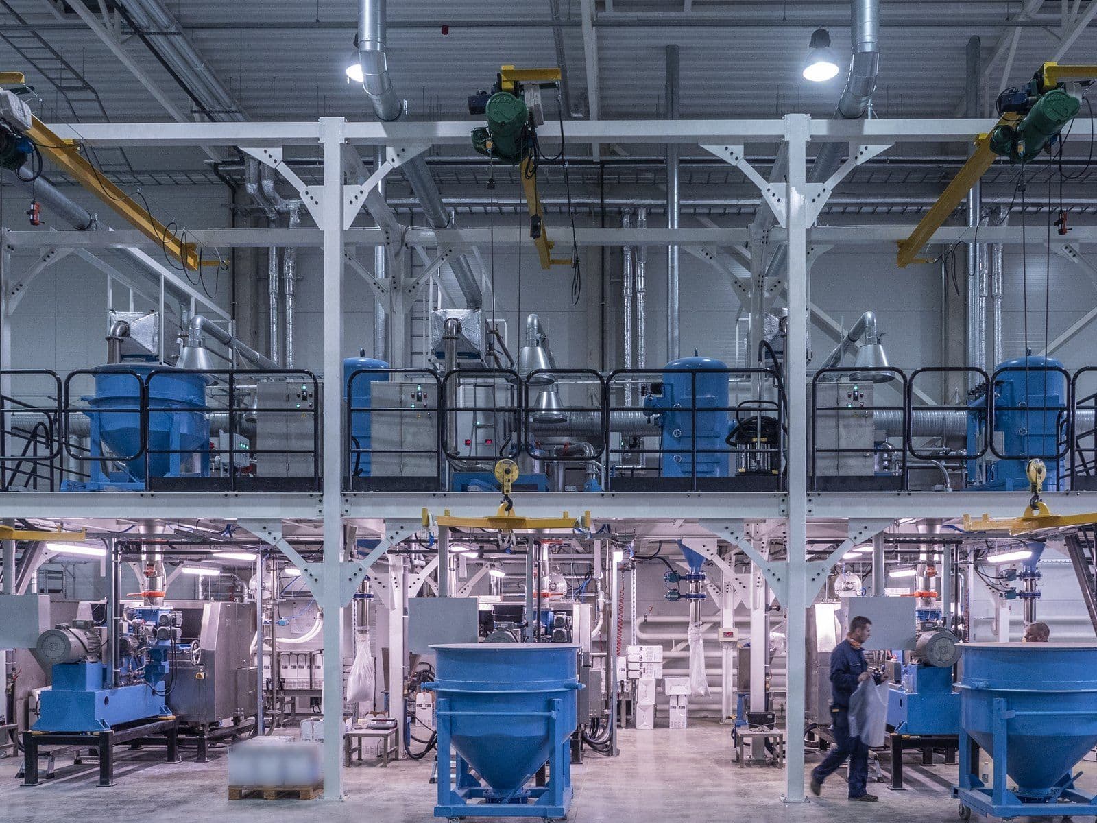 Powder production hall: mixing vessels on the upper deck and collection hoppers on the floor below